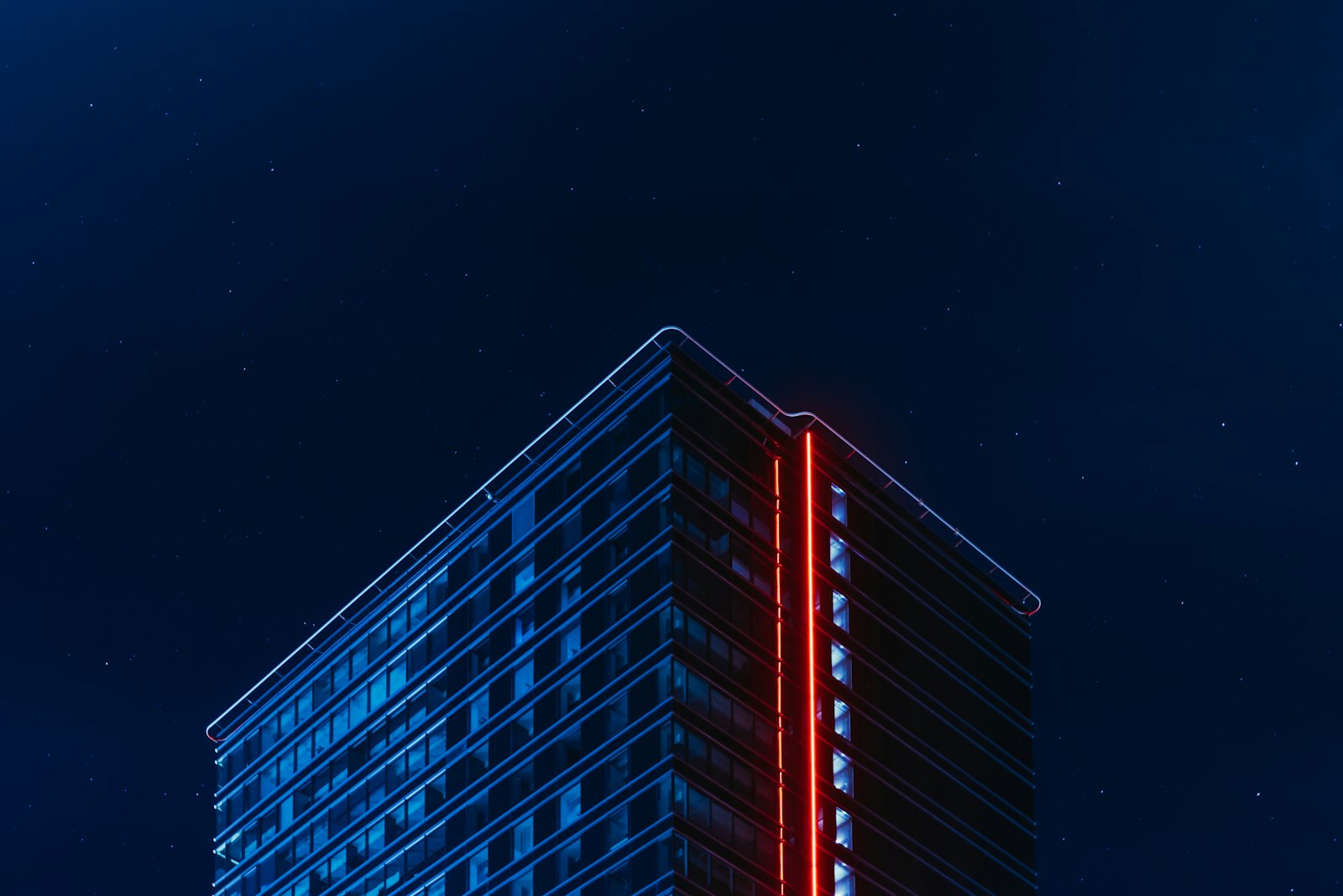 Modern glass building lit at night