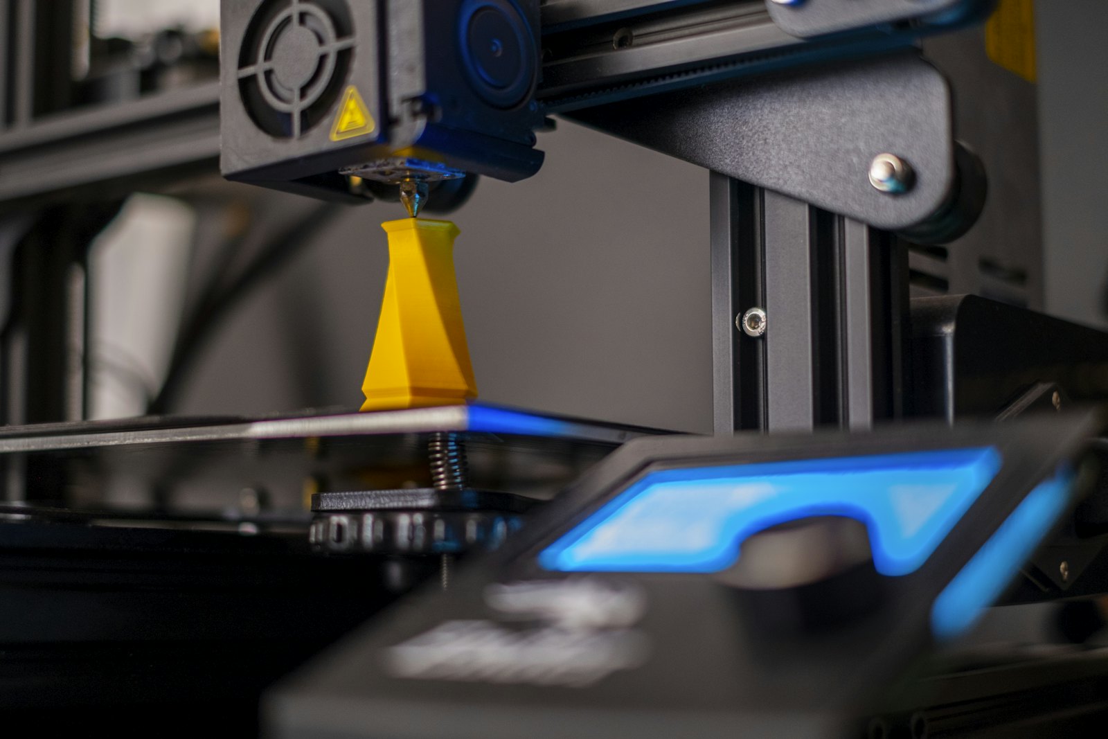 3D printer producing a yellow part