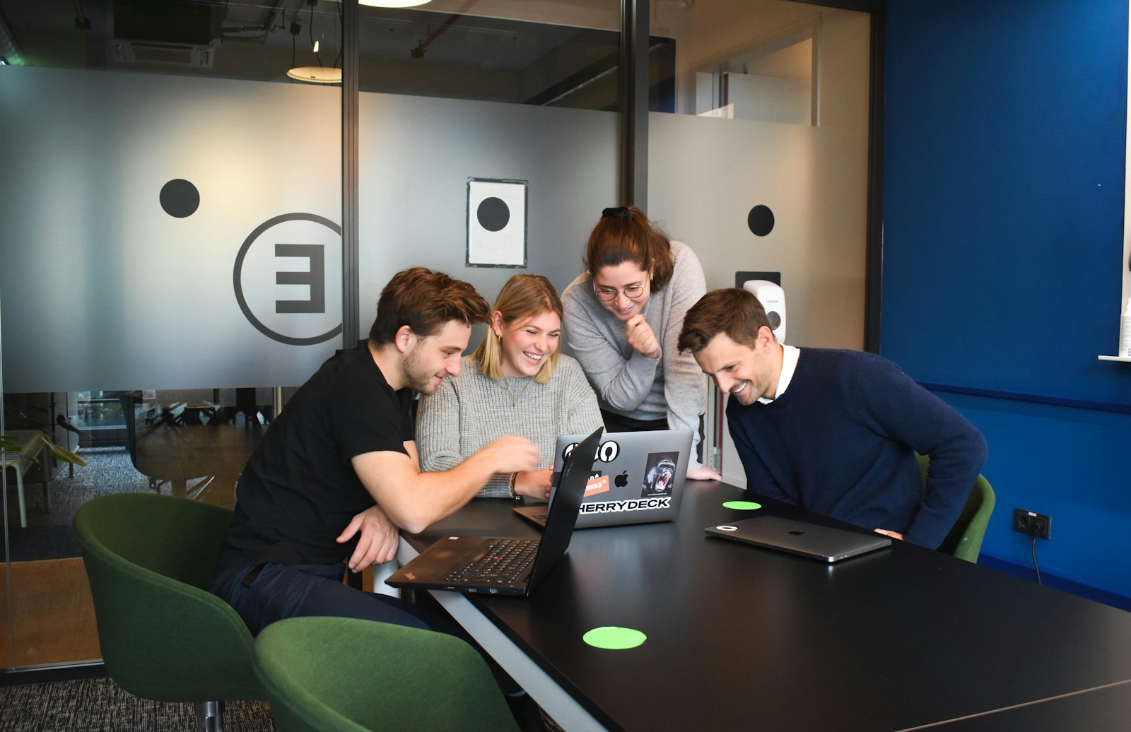 Team collaborating on laptops
